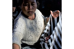 Image Indonesian woman holding a plastic bag.